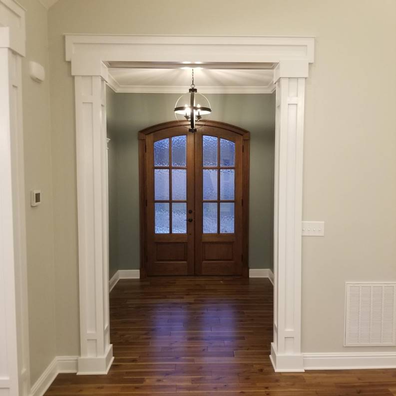 A bathroom with a white tub sitting next to a window

Description automatically generated