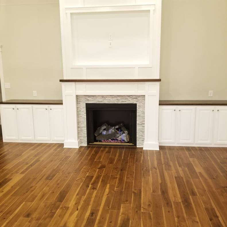 A room with a hard wood floor

Description automatically generated