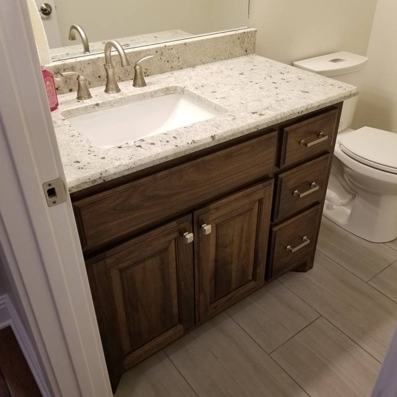 A bathroom with a sink and a mirror

Description automatically generated