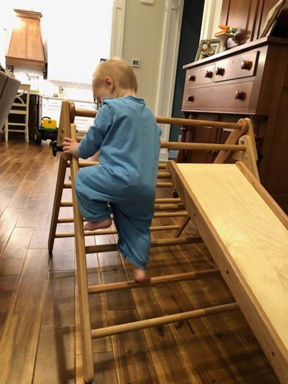 A person sitting on a stool

Description automatically generated with medium confidence