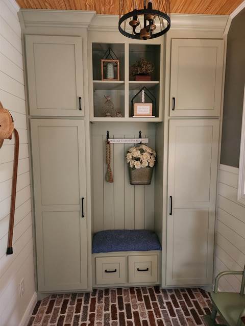 A white cabinet with shelves and a flower vase

Description automatically generated