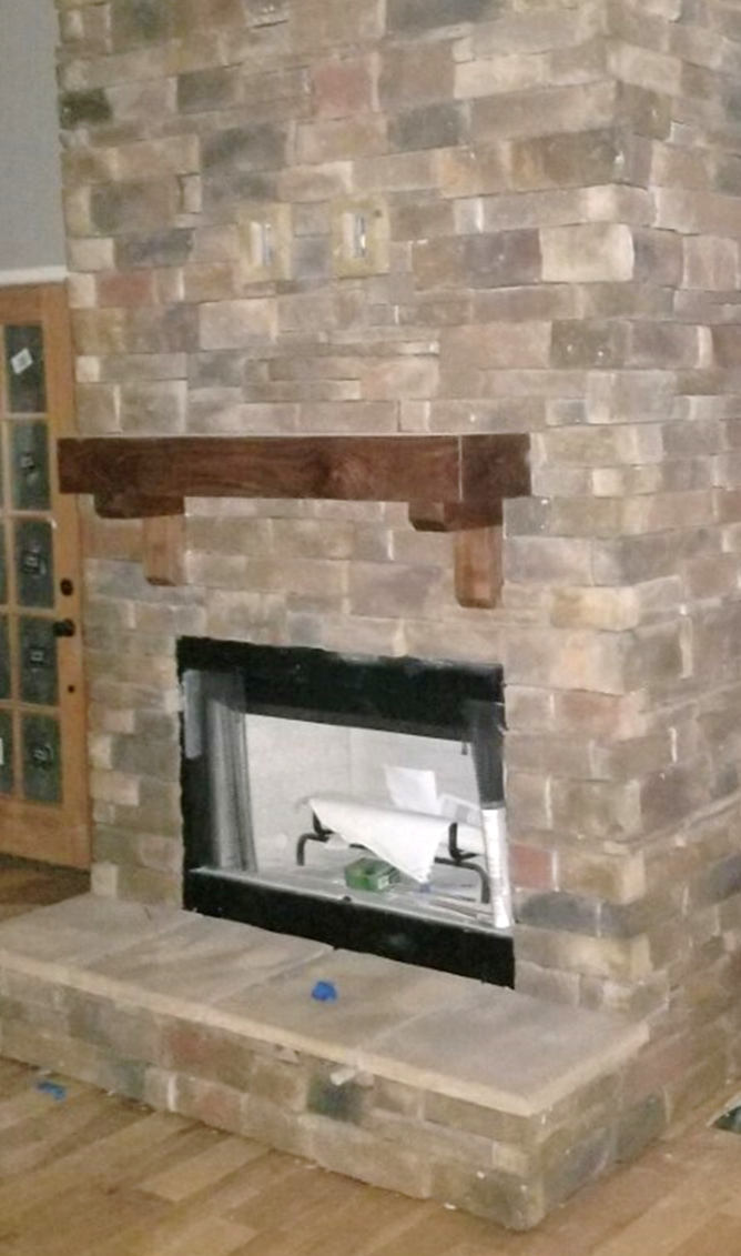 A living room with a fireplace

Description automatically generated