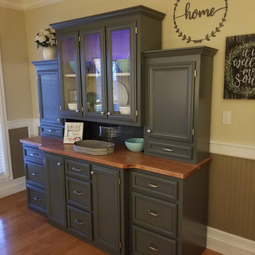 A kitchen with wooden cabinets and a window

Description automatically generated
