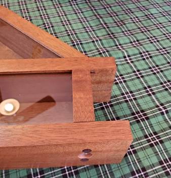 A picture containing wooden, sitting, fabric, green

Description automatically generated